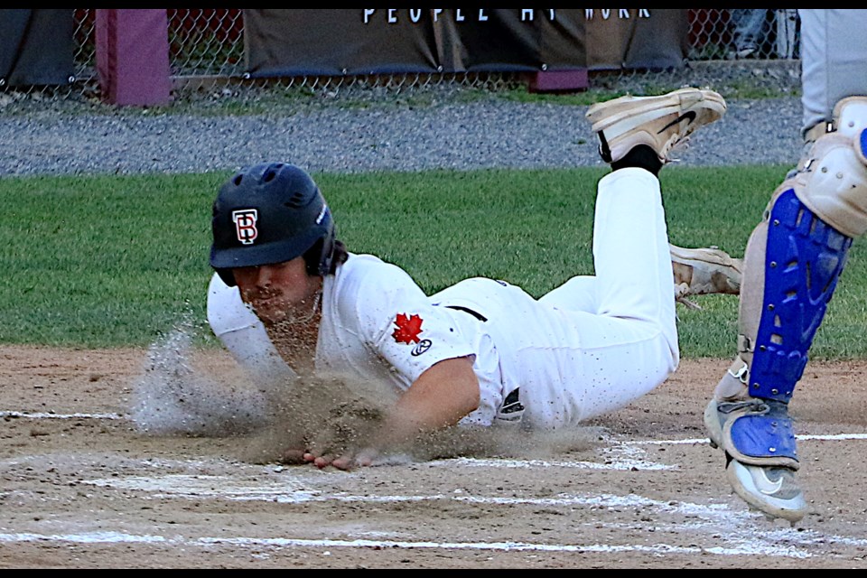 Hayden Stringfellow slides safely headfirst into home plate on Wednesday, July 2, 2025 against the Waterloo Bucks at Port Arthur Stadium. (Leith Dunick, tbnewswatch.com)