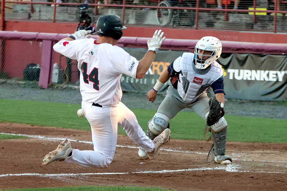Jacob Steinberg beats the throw to the plate and slides in safely before Eau Claire's Mkey Muniz can apply the tag on Saturday, July 26, 2025 at Port Arthur Stadium. (Leith Dunick, tbnewswatch.com)