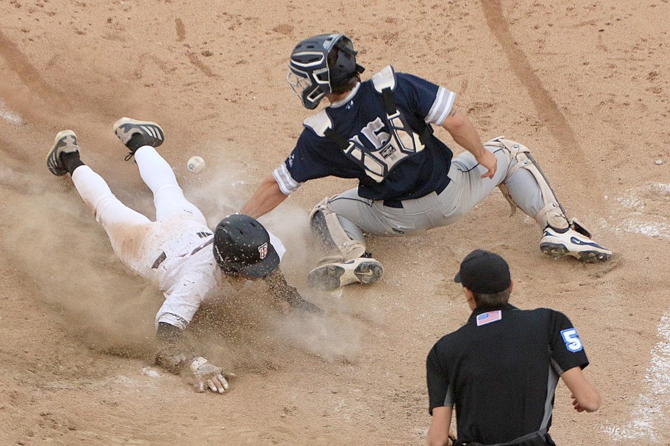 Thunder Bay's Kael Babin slides safely into home, Duluth catcher Kade Thompson unable to hang onto the ball, on Tuesday, June 3, 2025 at Port Arthur Stadium. (Leith Dunick, tbnewswatch.com)