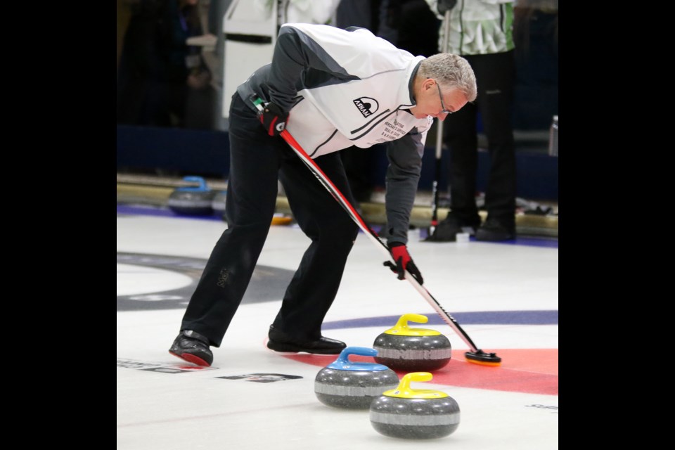 Gary Champagne sweeps for Team Hackner on Friday, Feb. 10, 2017 during Draw 5 at the 2017 Travelers Men's Provncials at Fort William Curling Club (Leith Dunick, tbnewswatch.com). 