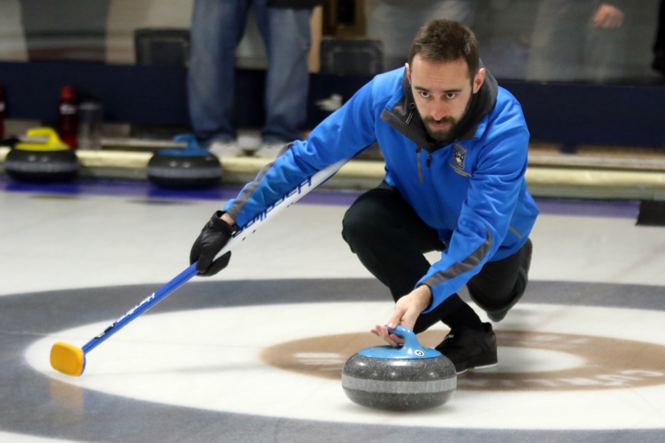 Dave Henderson of Lakehead University fires off a shot during the U Sports-Canada Curling University Championships at Fort William Curling Club (Leith Dunick, tbnewswatch.com). 