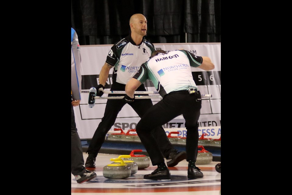 E.J. Harnden and Ryan Fry celebrate Brad Jacobs' game-winning shot on Suinday, Nov. 11, 2018 at the Pinty's Grand Slam of Curling Tour Chellenge at the Thunder Bay Tournament Centre. (Leith Dunick, tbnewswatch.com)