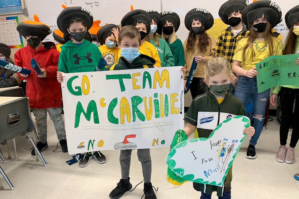 Krista McCarville's son, Kalin, and Ashley Sippala's daughter, Ava, lead the charge, chearing for Northern Ontario on Wednesday, Feb. 2, 2022 at Holy Family School. (Leith Dunick, tbnewswatch.com)