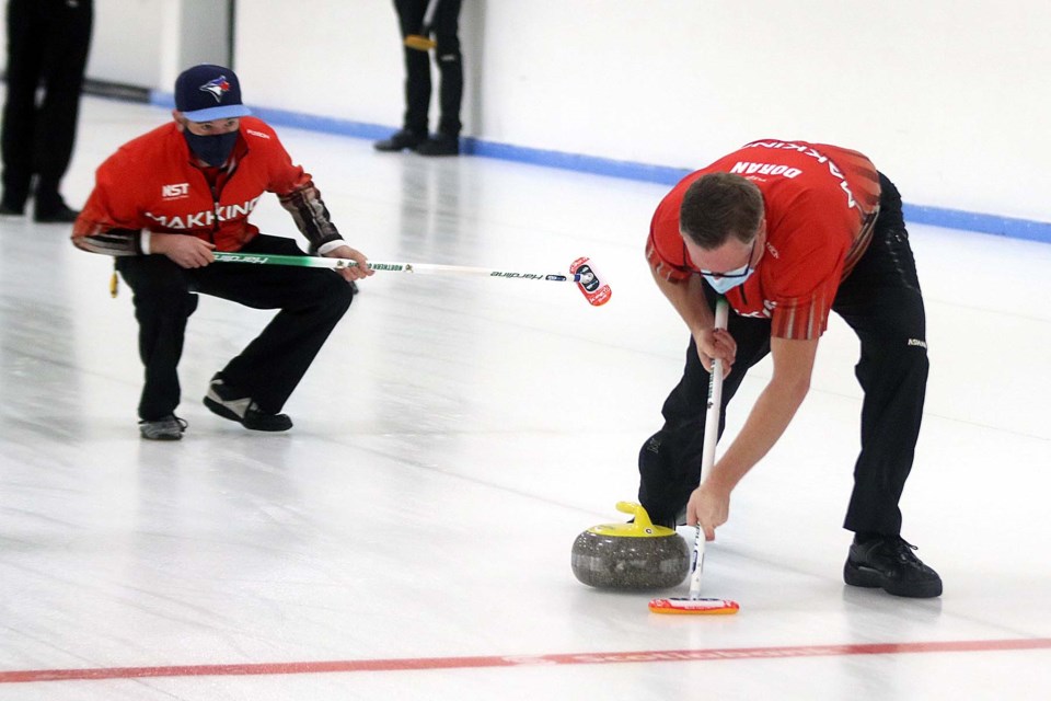 Skip Ben Mikkelsen (left) watches his shot on Wednesday, Dec. 2, 2020 at the Kakabeka Falls Curling Club. (Leith Dunick, tbnewswtdh.com