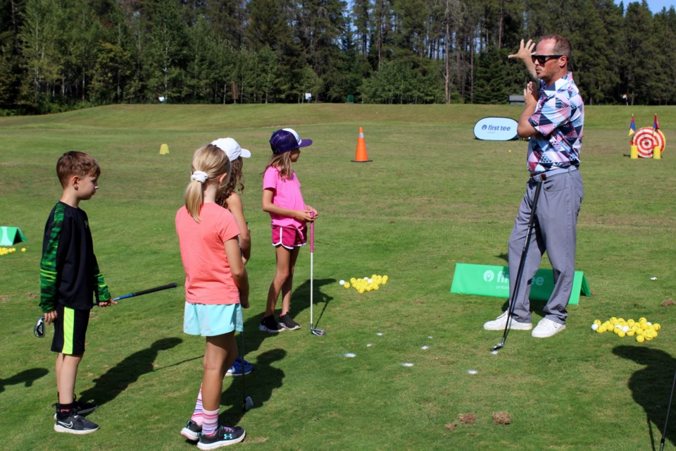 Chris Gardner runs through a chipping drill during a First Tee Canada youth golf lesson on Aug. 6 at the Whitewater Golf Club driving range.
