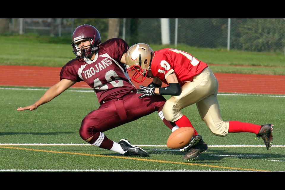 Hammarskjold's Nathan Smallwood (10) punishes Churchill's Ricardo Torres after a muffed punt on Thursday, Sept. 22, 2016 at Fort William Stadium (Leith Dunick, tbnewswatch.com)