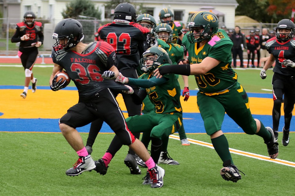 The Falcons Nick Doucette is taken down by Saints defenders Brayden Garton (66) and Alex Gollat-Luskleet on Thursday, Oct. 12, 2017 at St. Patrick field (Leith Dunick, tbnewswatch.com). 