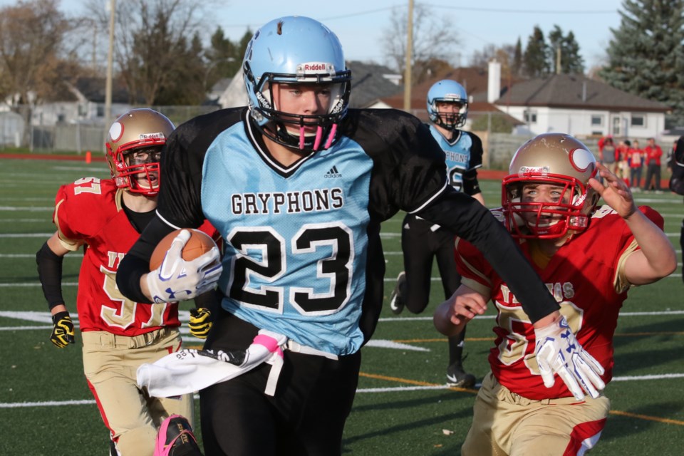 Superior's Owen Steele (23) outruns Hammarskjold's Trenton Couture (left) and Kevin Le for an 18-yard touchdown in the second quarter on Thursday, Oct. 19, 2017 at Fort William Stadium (Leith Dunick, tbnewswatch.com). 