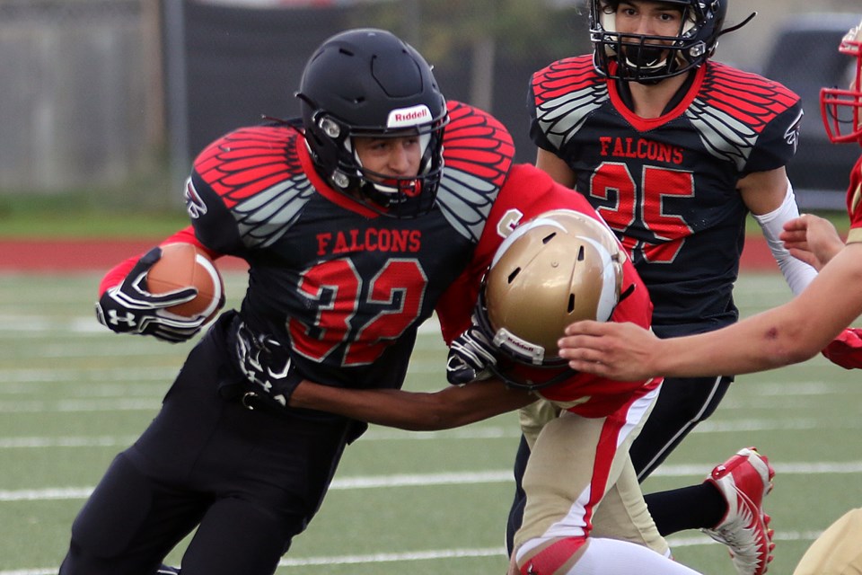 Harrison Tsekouras runs the ball for St. Ignatius on Thursday, Sept. 26, 2019, with Hammarskjold's Damiyen Malo hot in pursuit. (Leith Dunick, tbnewswatch.com)