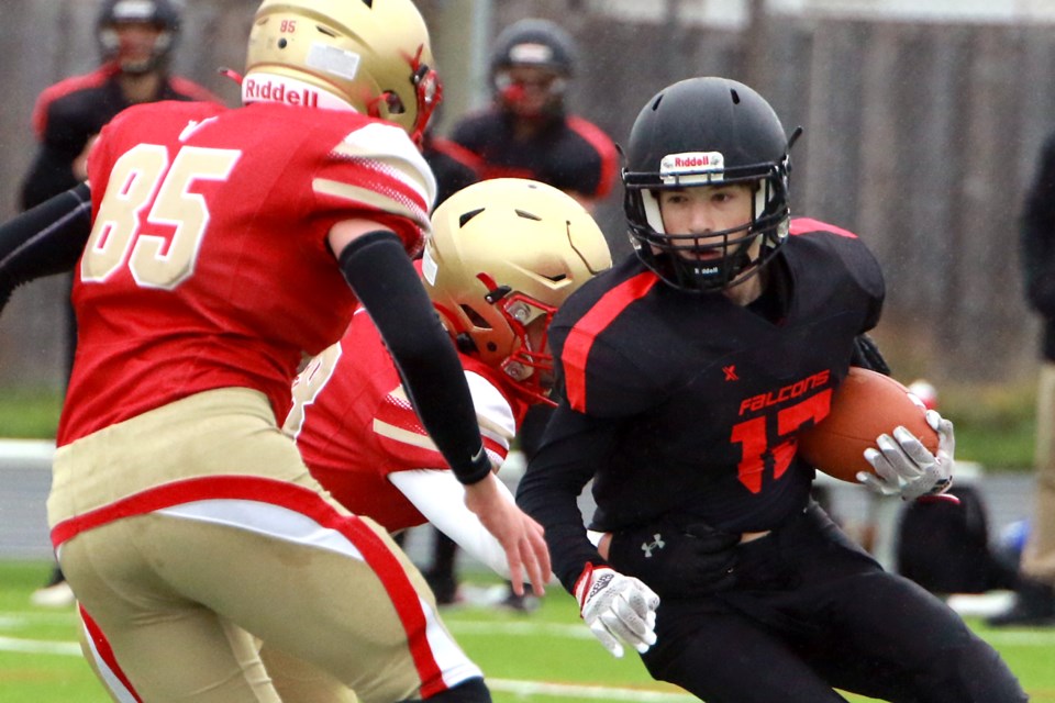 Carson Height is chased down by a couple of Hammarsjkold defenders, including Fisher Ruberto (left). Height later scored a receiving touchdown to help St. Ignatius down the Vikings 24-1 on Thursday, Oct. 19, 2023. (Leith Dunick, tbnewswatch.com)