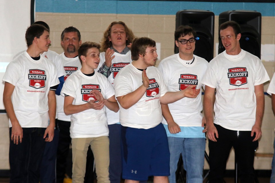 Members of the Superior Gryphons football team cheer the news the program will return to the school next fall (Leith Dunick, tbnewswatch.com). 