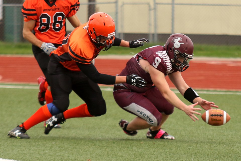 Westgate's Konnor Kooistra (left) tackle's Churchill quaterback Andrew Freitag in the end zone for a safety on Friday, Oct. 14, 2016 at Fort William Stadium (Leith Dunick, tbnewswatch.com).