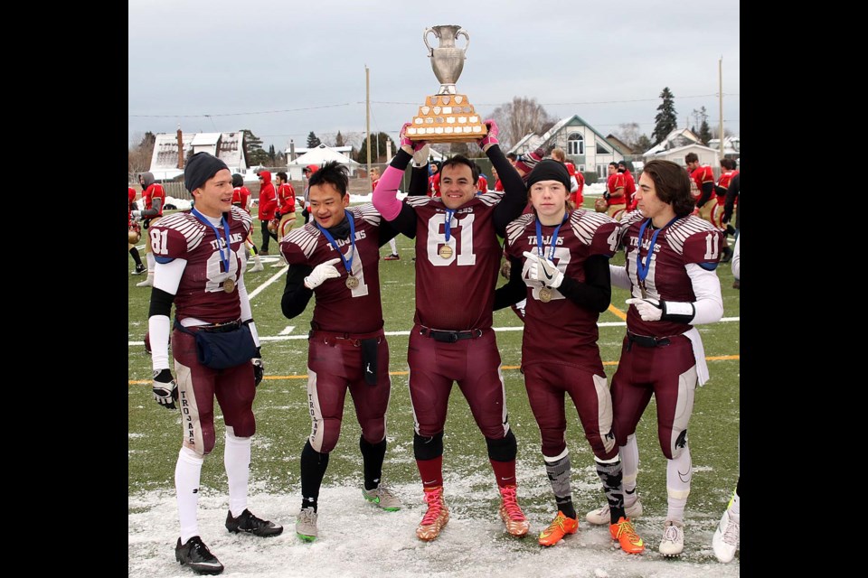Churchill captains James Basalyga (from left), Dyk Taw, Karl Waffler, Joey Wall and Braeden Prochnicki hoist the high school senior football championship trophy on Saturday, Nov. 18, 2017 at Fort William Stadium (Leith Dunick, tbnewswatch.com). 