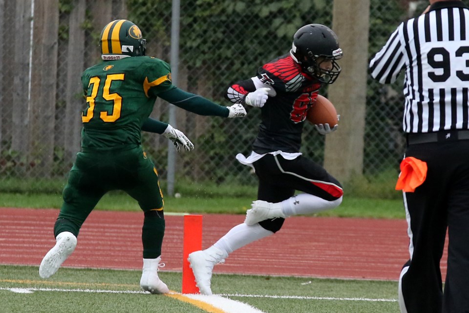 St. Pat's defender Xander Schriver (left) just managed to push St. Ignatius Falcons receiver Anthoy Valente out of bounds at the three-yard line on Saturday, Sept. 16, 2017 at Fort William Stadium (Leith Dunick, tbnewswatch.com). 