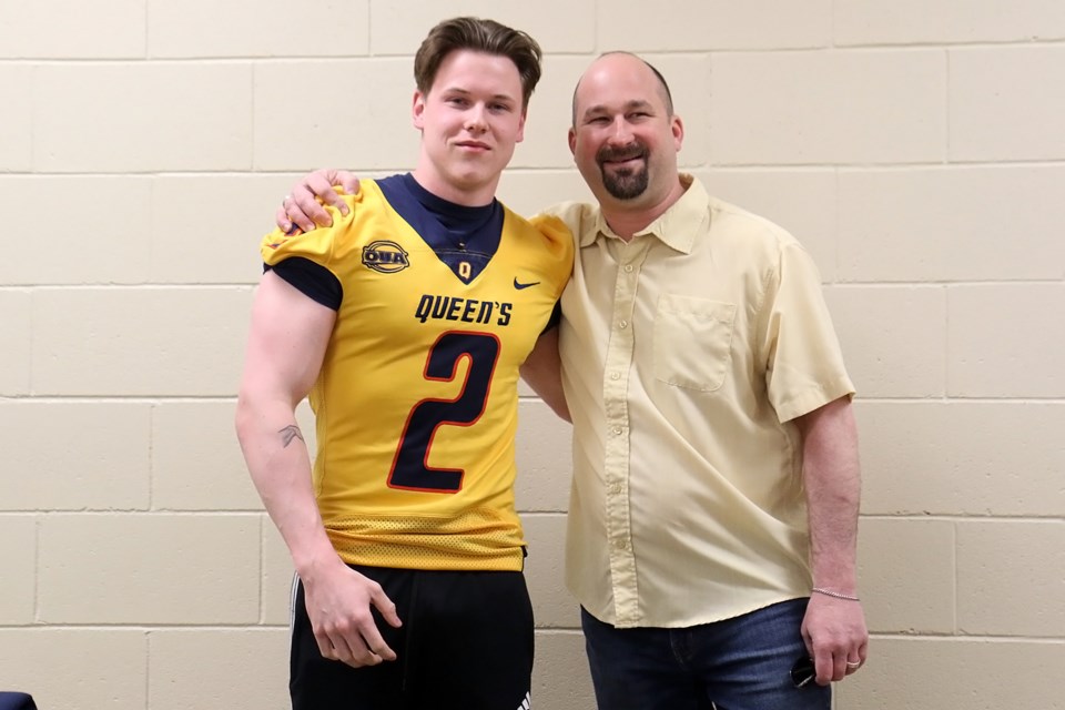 St. Ignatius Falcons receiver Noah Penfold (left) and his father Tim, on Saturday, April 27, 2019 pose after the  18-year-old football star announced his intentions to play for Queen's University in Kingston, Ont. (Leith Dunick, tbnewswatch.com)