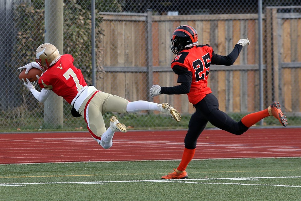 Hammarskjold's Ryan Laukka (left) makes a diving catch attempt on Saturday, Nov. 2, 2019, with Westgate's Trystan Basalyga hot in pursuit. (Leith Dunick, tbnewswatch.com)