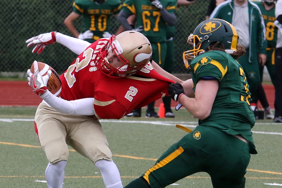 St. Patrick's Cam Monty hauls down Hammarskjold's Michael Goegan on Friday, Sept. 20, 2019 at Fort William Stadium. (Leith Dunick, tbnewswatch.com)