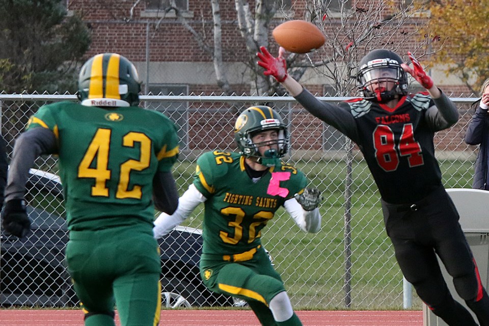 St. Ignatius receiver Jackson Lawrence makes an acrobatic grab with St. Patrick defenders Matteo Olsen (32) and Ryan Tilmon closing in on Friday, Oct. 22, 2021 at St. Ignatius High School. (Leith Dunick, tbnewswatch.com)