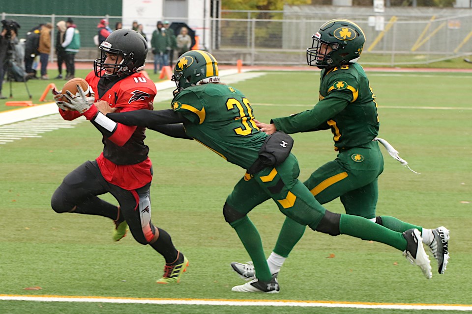 Falcons receiver Harry Tsekouras bolts across the goal line on Friday, Oct. 14, 2022, chased by St. Pattrick defenders Devin Richards and Manerplaw Winning. (Leith Dunick, tbnewswatch.com)