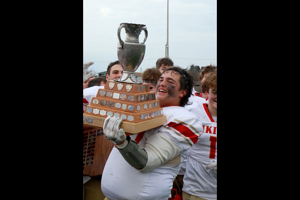 Hammarskjold's Chase Wrigley hoists the senior football championship trophy on Saturday, Nov. 4, 2023. (Leith Dunick, tbnewswatch.com)