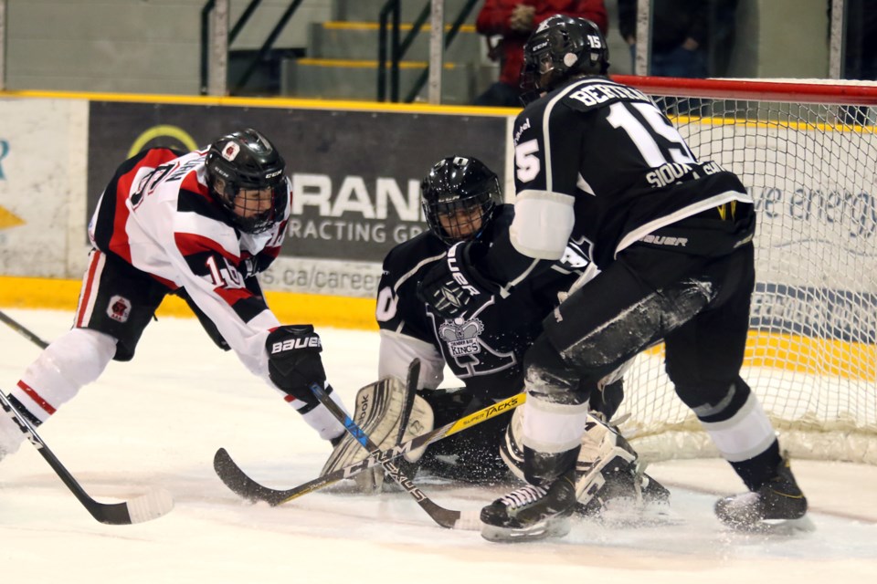 Ottawa's Sean McGurn fires the puck at Thunder Bay goalie Stephan Bourgeois as Kings forward Dylan Bertrand tries to clear the front of the net on Monday, March 27, 2017 at Fort William Gardens during the All Ontario Bantam AAA Championship in Thunder Bay (Leith Dunick, tbnewswatch.com). 