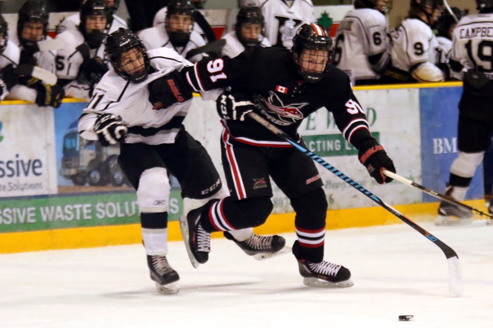 York-Simcoe Express forward Tyler Challis fights off Thunder Bay Kings defenceman Cole MacKenzie on Thursday, March 30, 2017 during the round-robin finale at the All Ontario Bantam AAA Championship at Fort William Gardens in Thunder Bay (Leith Dunick, tbnewswatch.com). 