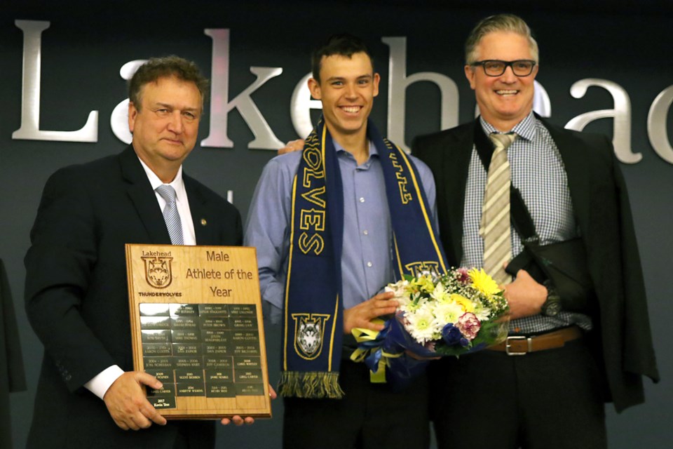 Runner Kevin Tree (centre) was presented with Lakehead University's male athlete of the year award on Saturday, Apri. 1, 2017 by school president Brian Stevenson and athletic director Tom Warden (Leith Dunick, tbnewswatch.com). 