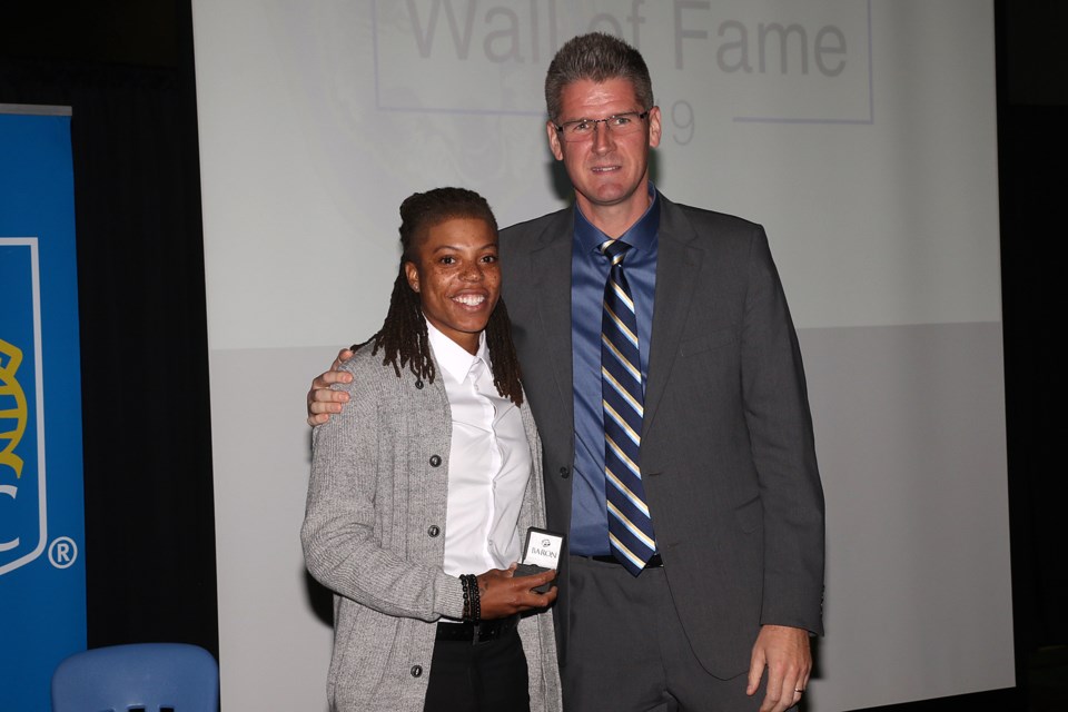 Jylisa Williams accepts her Lakehead Unviersity Wall of Fame ring from women's basketball coach Jon Kreiner on Saturday, Oct. 5, 2019. (Leith Dunick, tbnewswatch.com)