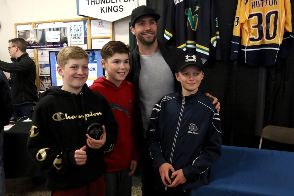 Buffalo goaltender Carter Hutton poses with fans Austin Polonoski, Calum Keating and Tanner Miller at the TELUS Cup on Wednesday, April 24, 2019 at Fort William Gardens. (Leith Dunick, tbnewswatch.com)