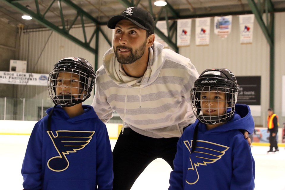Twins Ryan (left) and Baron Adams, 8, pose with St. Louis Blues defenceman Robert Bortuzzo on Tuesday, July 25, 2017 at the Tournament Centre (Leith Dunick, tbnewswatch.com). 