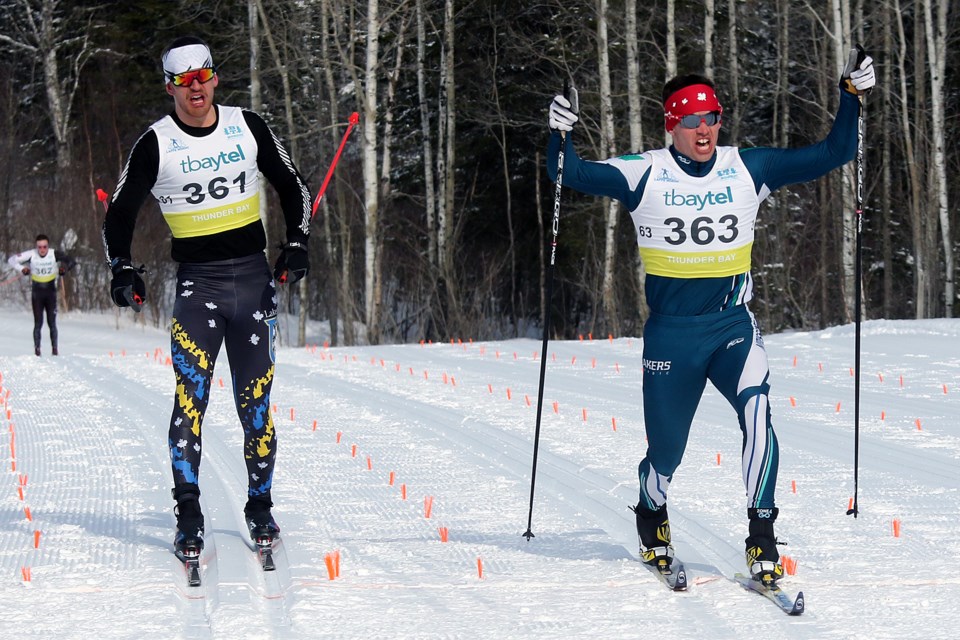 Nipissing's Jordan Cascagnette (right) edges Lakehead's Noah Thompson at the finish line on Saturday, Feb 24, 2018 to capture the men's classic relay at the OUA Nordic Championship at Lappe Nordic Centre. (Leith Dunick, tbnewswatch.com)