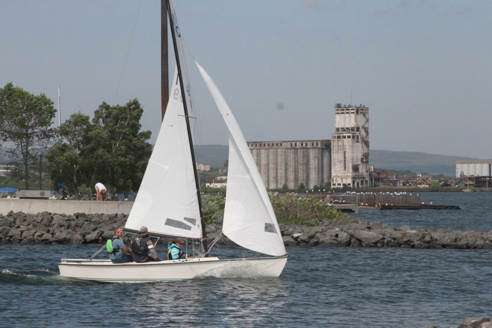 Richard Walsh (left), Alex Cox and Nikka Stoger practicing for the 2019 Pan-American Games on Lake Superior at Marina Park on July 26, 2019. (Michael Charlebois, tbnewswatch) 