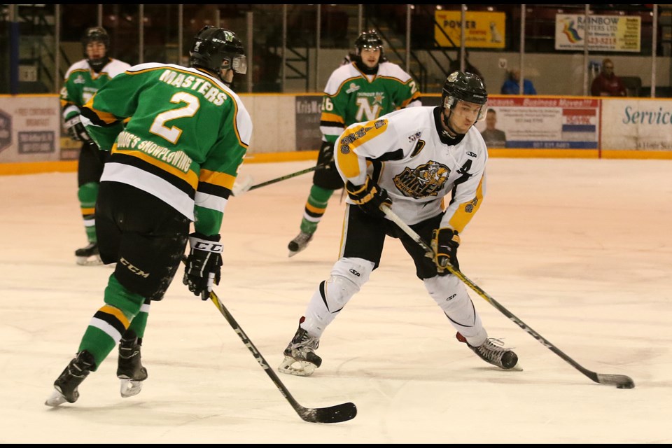 English River's Trevor Pereverzoff fires a shot at the Thunder Bay net, as North Stars defenceman Jonathan Masters attempts the block on Saturday, March 18, 2017 at Fort William Gardens (Leith Dunick, tbnewswatch.com). 