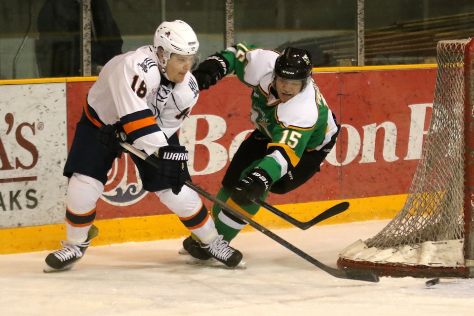 Thief River Falls defenceman Jack Dunnell and Thunder Bay blue-liner Aaron Wesley-Chisel chase after the puck on Friday, March 17, 2017 at Fort William Gardens (Leith Dunick, tbnewswatch.com). 