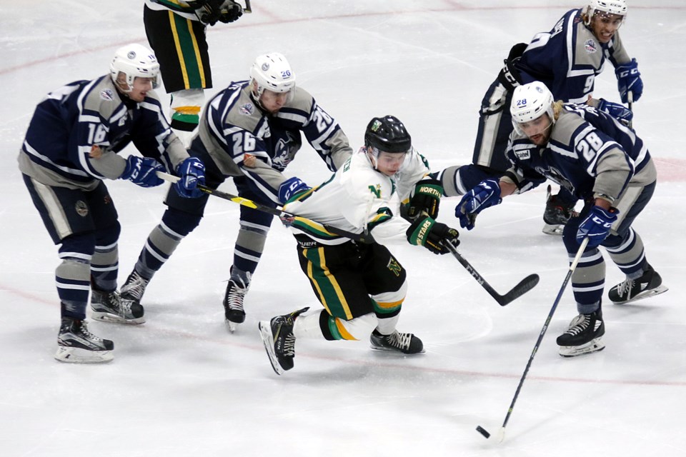 Thunder Bay's Kyle Auger (28) attempts to weave his way through a quarter of Dryden Ice Dogs, Braden Shea (16), Ryan Brandt (26), Kevin Parra-Vaughn (28) and Rayman Bassi (9) on Thursday, March 28, 2019 at Fort William Gardens. (Leith Dunick, tbnewswatch.com)