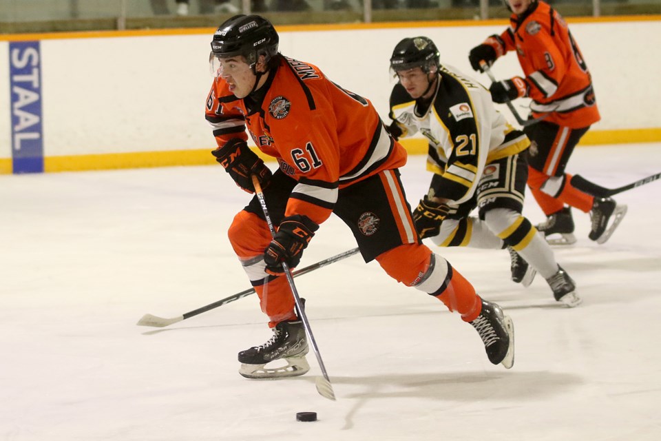 Kam River's Trenton Morriseau (left) is chased down by Red Lake's Mathieu Harrold on Friday, Feb. 25, 2022 at the Norwest Arena. (Leith Dunick, tbnewswatch.com)