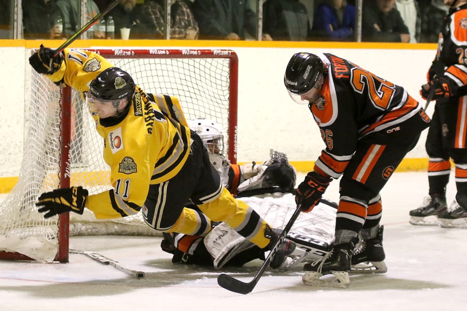 Red Lake's Jordan Baranesky flies through the air after beating Kam River goaltender Austin Madge during second-period play on Thursday, April 21, 2022 at the Norwest Arena (Leith Dunick, tbneswatch.com)