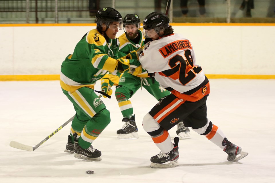 Thunder Bay's Kyler Belluz (left) looks to stop Kam River's Kyle Lamoreux, who later netted the overtime winner on Sunday, Nov. 28, 2021. (Leith Dunick, tbnewswatch.com)