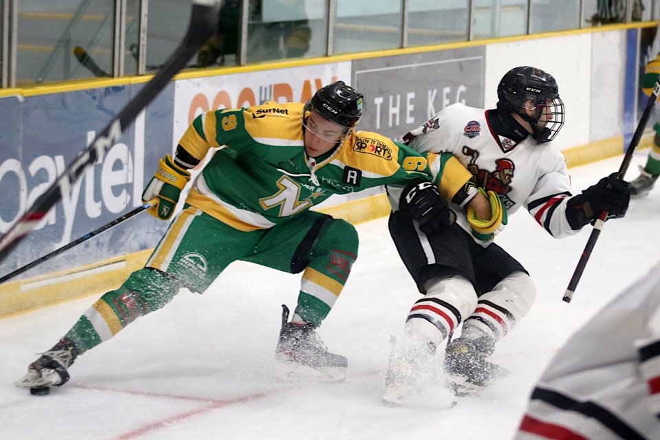 Lou Vesperini (left) battles for the puck with Wisconsin's Jake Smith  on Saturday, Oct. 16, 2021. (Leith Dunick, tbnewswatch.com)