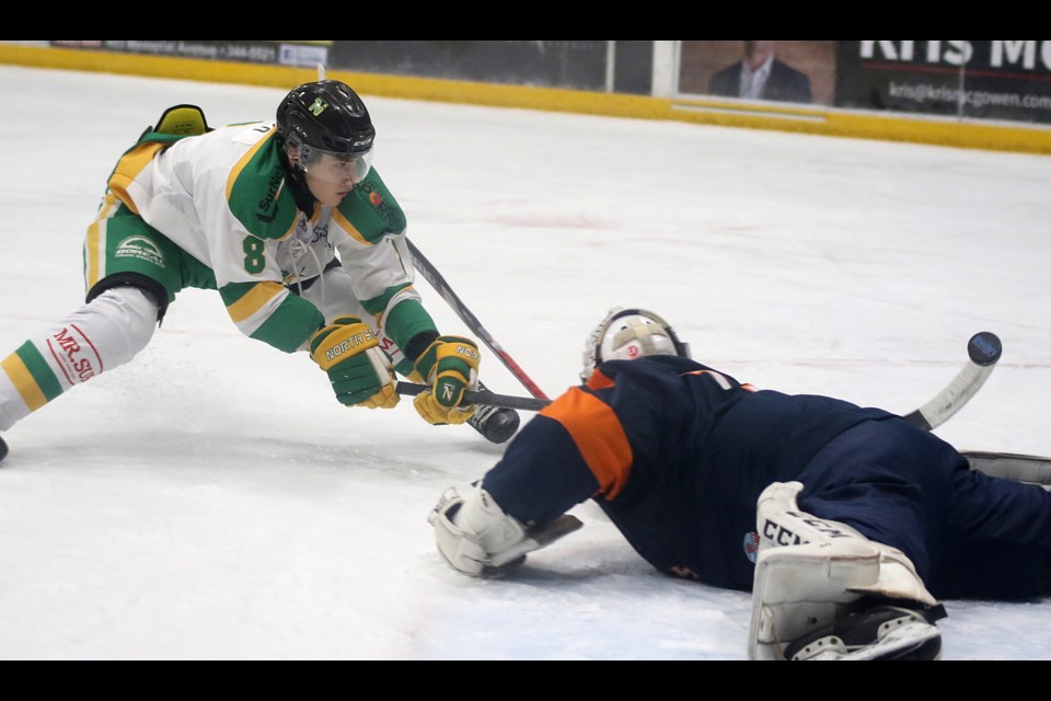 Thunder Bay's Anthony Kuzenko lifts the puck over sprawling Thief River Falls goaltender Sean Guerin on Friday, Dec. 3, 2021. (Leith Dunick, tbnewswatch.com)