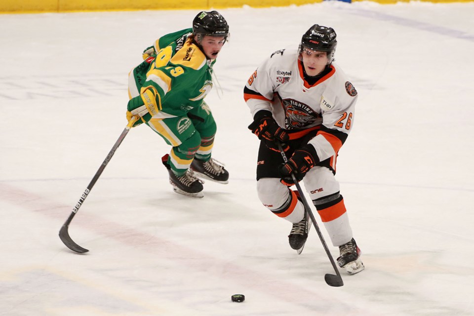 Thunder Bay's Noah Broughton (left) tries to change gears to track down Kam River's Jack Cook on Friday, Dec. 2, 2022 at Fort William Gardens. (Leith Dunick, tbnewswatch.com)