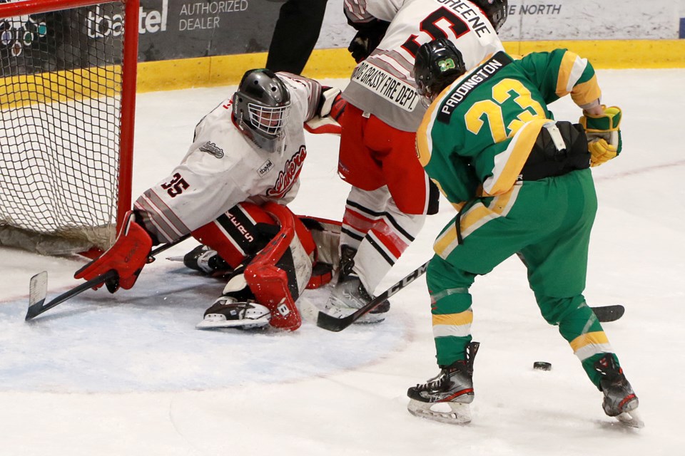 Thunder Bay's E.J. Paddington looks for the puck in front of Fort Frances goaltender Ryan Tanner on Wednesday, Jan. 25, 2023 in SIJHL play at Fort William Gardens. (Leith Dunick, tbnewswatch.com)