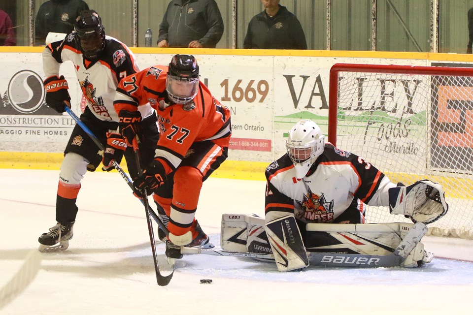 Hearst's Jacob Emmanuel Jr. (left) tries to stop Kam River's Max Wright from moving in on Lumberjacks goaltender Tristan Boileau on Friday, Sept. 1, 2023 at the Norwest Arena. (Leith Dunick, tbnewswatch.com)