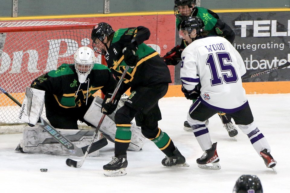 Thunder Bay goaltender Liam Letters eyes the puck on Saturday, Jan. 11, 2025 in his debut outing with the North Stars, as teammate Tag Bryson and Fort Frances forward Jack Wood look on. (Leith Dunick, tbnewswatch.com)