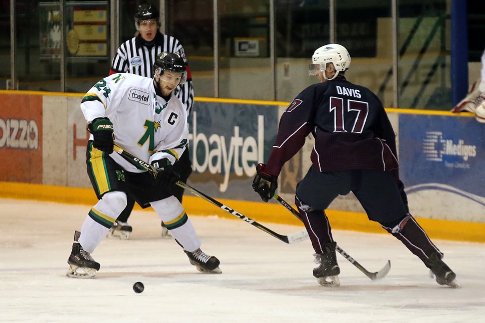 Thunder Bay's Joe Newhouse and Dryden's Ted Davis chase after the puck on Wednesday, April 18, 2018 at Fort William Gardens in Game 4 of the SIJHL championship. (Leith Dunick, tbnewswatch.com)