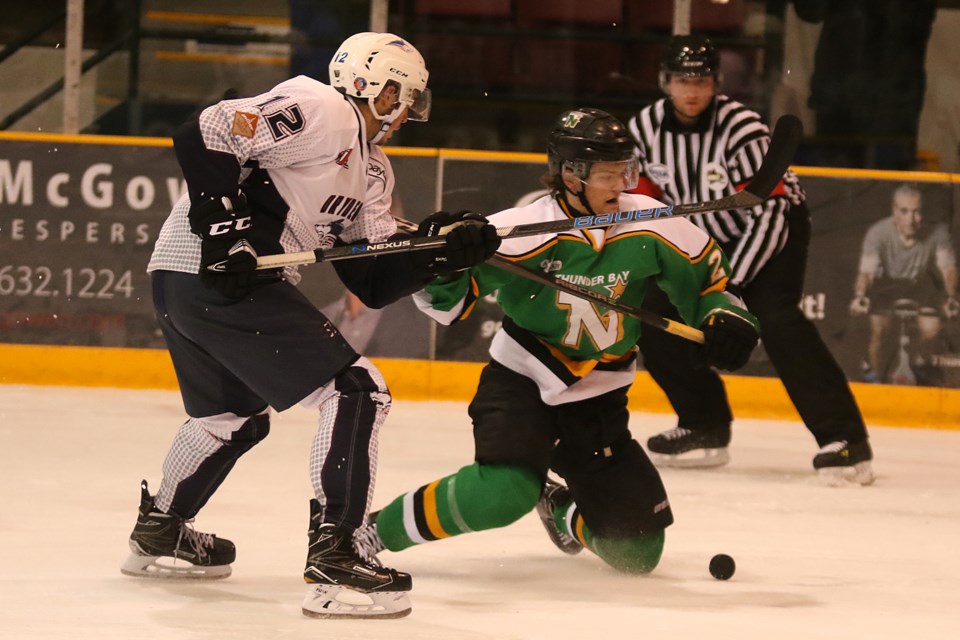 Thunder Bay's Keighan Gerrie (right) falls to his knees in pursuit of the puck against Dryden's Cory Dennis on Saturday, Oct. 14, 2017 at Fort Wiliam Gardens (Leith Dunick, tbnewswatch.com). 