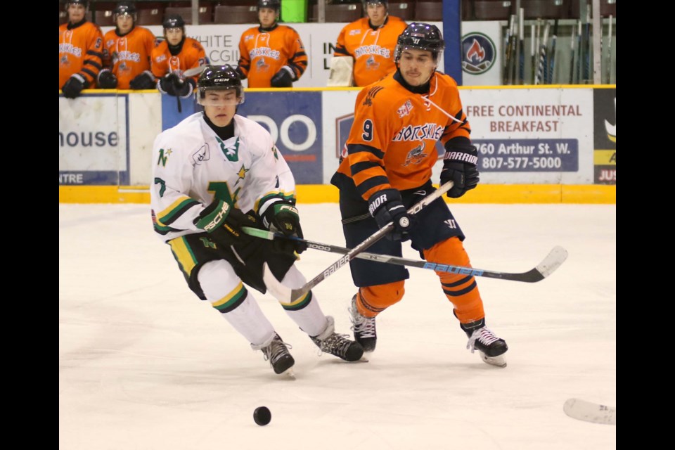 Thunder Bay's Dillon Ward (left) and Thief River Falls' Boe Bjorge race for the puck on Saturday, Nov. 11, 2017 at Fort William Gardens (Leith Dunick, tbnewswatch.com)