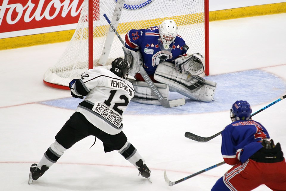 Christian Veneruzzo fires the puck past Calgary goalie Garin Bjorkland in opening game action at the 2019 TELUS Cup on Monday, April 22, 2019 at Fort William Gardens. (Leith Dunick, tbnewswatch.com)