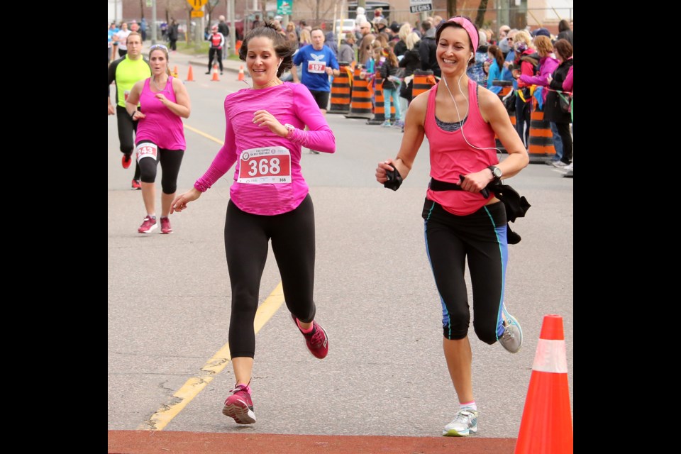 A pair of runners reach the finish line at the Firefighters Ten Mile Road Race course on Monday, May 22, 2017 (Leith Dunick, tbnewswatch.com). 