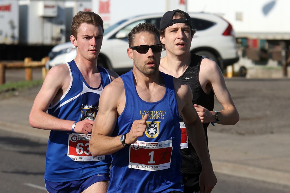 Trevor Zimak (centre) outduels Scott Behler (right) and Derek Patteron on Monday, May 21, 2018 to capture his third straight Firefighters Ten Mile Road Race. (Leith Dunick, tbnewswatch.com)